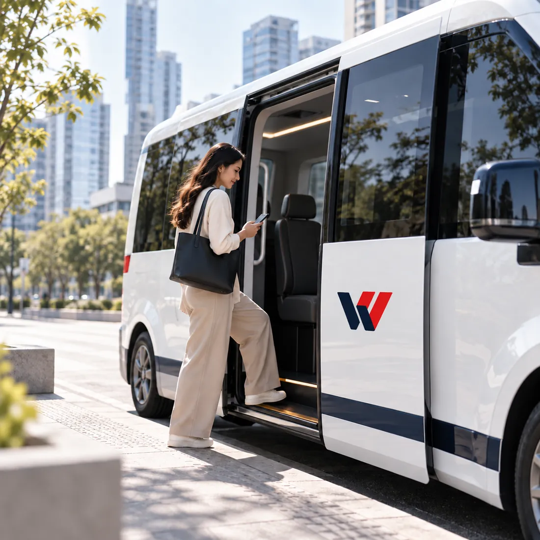 Woman boarding a WEMOVV shuttle while checking her phone